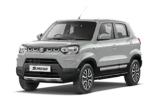 Mobil Suzuki S-Presso warna silver parkir di area terbuka, terlihat dari sisi depan samping.