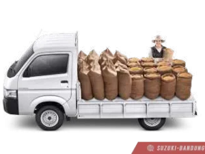 Suzuki Carry Pick Up baru warna putih, tampak dari depan samping, diparkir di luar ruangan.